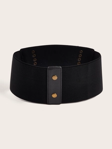 Close-up of black elastic corset belt with leather panel and gold metal snap buttons