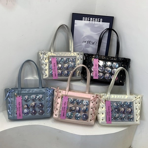 Glossy faux leather ita bags in five colors featuring clear windows and ribbon details