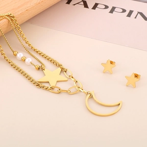 Detail of layered gold necklace with star and moon pendants and matching star stud earrings