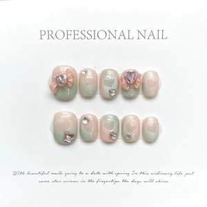 Pink and mint green gradient press-on nails with 3D bows and heart crystal rhinestones