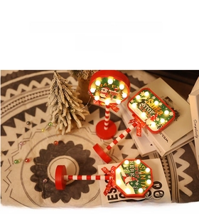 Close-up of LED Christmas Stop sign with Santa illustrations and warm festive lights