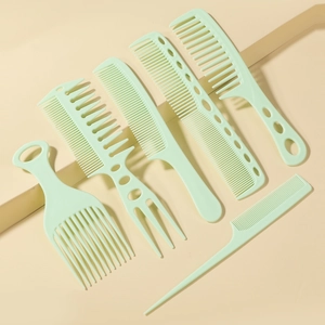 Detailed view of a 6-piece light green hair comb set arranged on a beige tiered surface