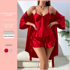 Three-piece red satin sleepwear set with camisole, ruffled shorts, and long robe