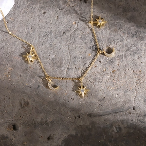 Elegant gold 925 sterling silver necklace featuring celestial star and moon pendants