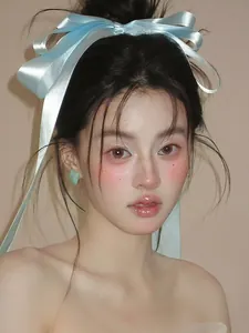 Close-up of light blue satin ribbon bow hair clip with polished surface and soft sheen