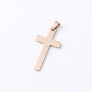 Detail of rose gold stainless steel cross pendant with a high-polished mirror finish
