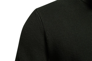 Detailed close-up of dark green ribbed knit fabric and shoulder seams on a men's sweater