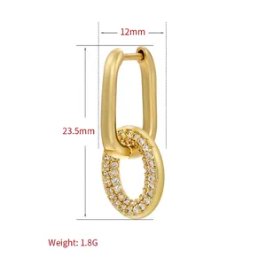 Luxury gold oval hoop earring featuring a pavé heart pendant with sparkling white zircons