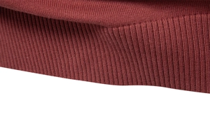 Macro shot of dark red rib-knit cotton fabric detail on a men's V-neck sweater