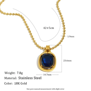 Detailed view of an 18K gold plated stainless steel necklace with a blue gemstone pendant