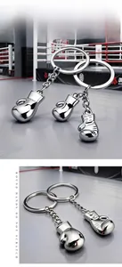 Polished zinc alloy boxing glove keychain with detailed stitching and silver finish