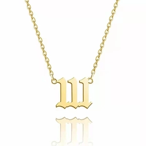 Close-up of golden number 111 pendant in Old English font on stainless steel necklace