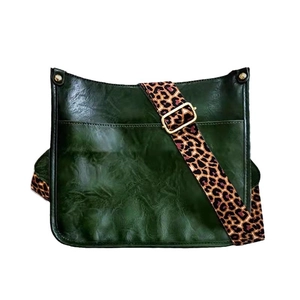 Dark green faux leather tote bag featuring a wide leopard print fabric shoulder strap