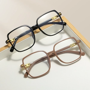 Square oversized blue light blocking glasses in black and taupe with gold metal accents