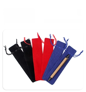 Detailed view of plush velvet drawstring pen pouches in black, red, and blue colors