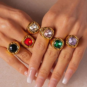 Close-up of set of six vintage gold square rings with colorful geometric zircon gemstones