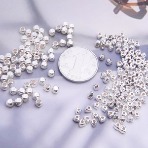 S925 sterling silver geometric spacer beads for DIY jewelry making next to a coin