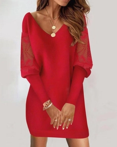 Detail of red V-neck dress featuring delicate lace stitching on long sleeves and slim fit