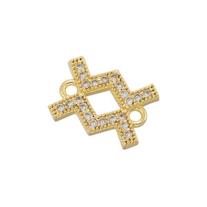 Macro detail of gold-plated connector charm with micro-paved white zircons and dual loops