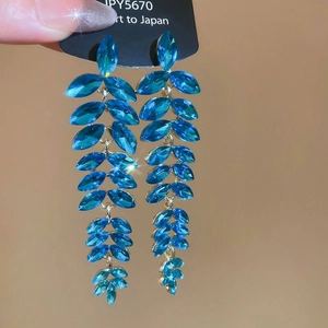 Elegant silver tassel earrings with blue crystals in a multilayered leaf shape design