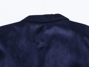 Detail view of navy blue velvet blazer collar and smooth texture on fabric