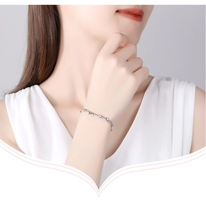 Close-up of a double-layer 925 silver star bracelet worn on a female wrist