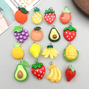 Detailed view of colorful resin fruit and vegetable charms with metal hanging loops
