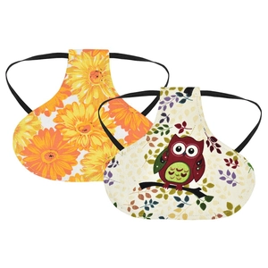 Detail of printed fabric hen saddles with sunflower and owl patterns and elastic straps