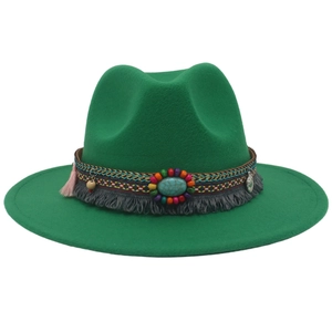 Close-up of emerald green felt cowboy hat with ethnic beads, turquoise and tassels