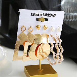 Detailed view of a 6-pair gold earrings set featuring pearls, hearts, and geometric designs