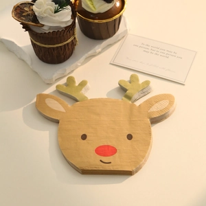 Detail view of reindeer shaped paper napkins with gold foil antlers for Christmas parties