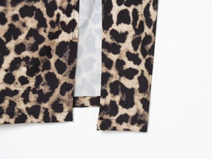 Detail of leopard print dress showing high-quality stitching and fabric texture on a split hem