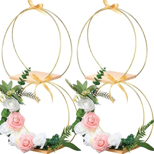 Set of 4 golden metal floral hoops with wooden bases and roses for wedding table decor