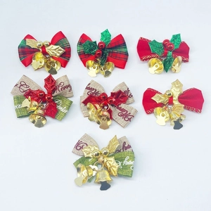 Detail of Christmas tree bows with small metal bells in red, green and plaid patterns