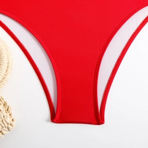 Detailed close-up of red swimsuit crotch stitching with soft white inner lining