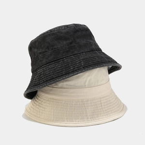 Washed vintage bucket hats in black and beige, featuring reinforced stitching detail