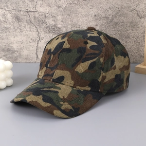 Detail of camouflage corduroy baseball cap showing textured fabric and six-panel crown