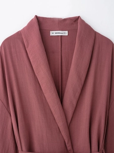 Detailed close-up of the V-neckline and size label on the dusty pink pajama-style top