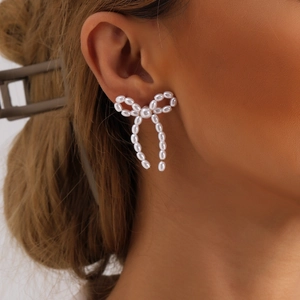 Vintage style handmade faux pearl bow stud earrings for women with elegant cream luster