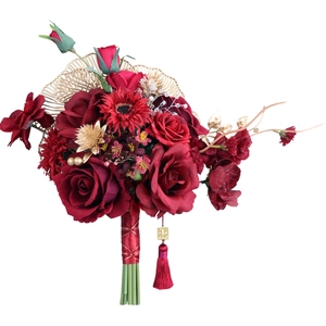 Traditional Chinese wedding bridal bouquet with red roses, gold leaves and double happiness tassel