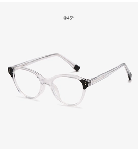 Detail view of transparent cat-eye glasses with black contrast tips at a 45-degree angle