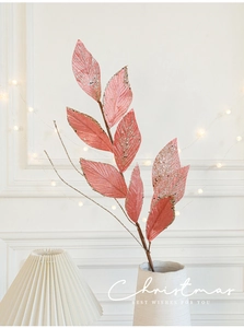 Pink Christmas velvet leaves with gold glitter in a ceramic vase for festive home decor
