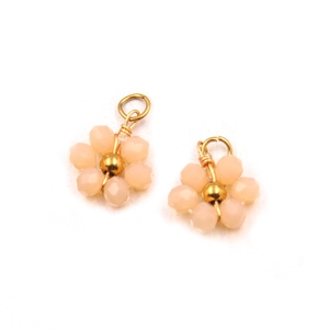Detailed view of handmade pink beaded flower charms with gold accents and jump rings