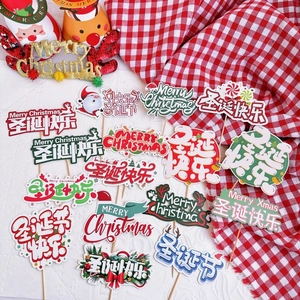 Festive Merry Christmas paper cake toppers set in red and green on checkered cloth