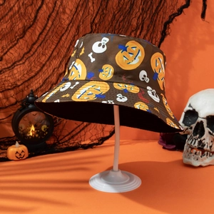 Detail of Halloween bucket hat with pumpkin and skull patterns on festive backdrop