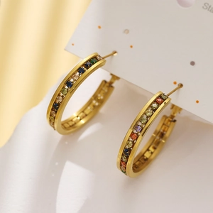 Detail of gold titanium steel hoop earrings featuring vibrant multicolor zircon stones