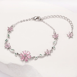 Detailed view of pink cherry blossom chain bracelet with inlaid zircons and lobster clasp