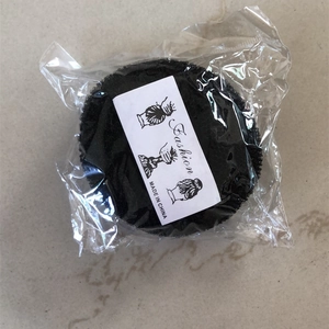 Black circular bun maker for kids hair styling in clear packaging with fashion card