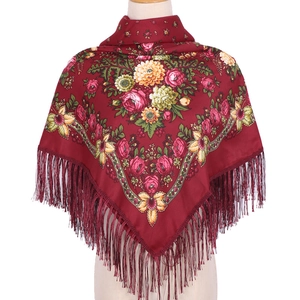 Detail of red floral ethnic scarf with fringe on a beige mannequin, 90x90cm square wrap