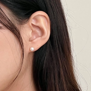 Classic 925 sterling silver pearl stud earrings shown on model for elegant look